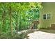 Back exterior view showcasing the deck, walkout basement, and natural wooded landscape at 2417 Labelle Dr, Waxhaw, NC 28173
