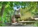 Back exterior view featuring a spacious deck, stairs, and serene wooded surroundings at 2417 Labelle Dr, Waxhaw, NC 28173