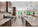 Spacious kitchen features granite countertops, stainless steel appliances and hardwood floors at 2417 Labelle Dr, Waxhaw, NC 28173