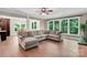 Spacious living room boasting large windows with natural light, hardwood floors, and a comfortable sectional sofa at 2417 Labelle Dr, Waxhaw, NC 28173