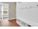 Practical mud room with white wainscoting, built-in bench, and easy access to the home's interior at 2417 Labelle Dr, Waxhaw, NC 28173