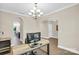 Spacious office area with a chandelier, wood floors and an arched doorway at 2417 Labelle Dr, Waxhaw, NC 28173