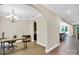 Bright office with hardwood floors, modern chandelier, and multiple archways to other rooms at 2417 Labelle Dr, Waxhaw, NC 28173