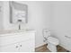 Modern bathroom features a white vanity with a framed mirror and wood look flooring at 3056 Goble St, Gastonia, NC 28056