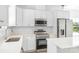 Modern kitchen featuring stainless steel appliances, quartz counters, and ample white cabinetry at 3056 Goble St, Gastonia, NC 28056