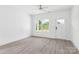 Bright living room featuring hard surface floors, a ceiling fan, and natural light from a large window at 3056 Goble St, Gastonia, NC 28056