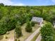 An aerial view of a house on a lush lot with mature trees, showcasing the property's landscaping and curb appeal at 3179 Westview Rd, Concord, NC 28025