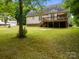 Expansive backyard with green lawn and a wooden deck on the back of the house at 3179 Westview Rd, Concord, NC 28025