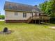 Spacious backyard with a deck, lush green grass, and mature trees offering privacy at 3179 Westview Rd, Concord, NC 28025