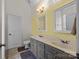 Bright bathroom with double vanity, grey cabinets, and neutral tile flooring at 3179 Westview Rd, Concord, NC 28025