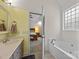 Relaxing bathroom with soaking tub, vanity, and open doorway to the bedroom at 3179 Westview Rd, Concord, NC 28025
