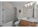 Well-lit bathroom features a shower-tub combo, single sink vanity, and decorative accents at 3179 Westview Rd, Concord, NC 28025
