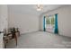Spacious bedroom with neutral carpet and paint, and large window with bright teal curtains at 3179 Westview Rd, Concord, NC 28025