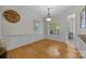 Formal dining room with hardwood floors, stylish wainscoting, and plenty of natural light at 3179 Westview Rd, Concord, NC 28025
