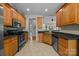 Traditional kitchen featuring wood cabinets, stainless appliances, and an easy to clean tile floor at 3179 Westview Rd, Concord, NC 28025
