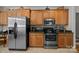 A well-appointed kitchen features wooden cabinets, stainless steel appliances, and mosaic backsplash at 3179 Westview Rd, Concord, NC 28025