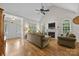 Bright living room featuring hardwood floors, a fireplace, and ample natural light from large windows at 3179 Westview Rd, Concord, NC 28025