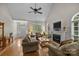 Cozy living room featuring hardwood floors, a fireplace, and ample natural light from large windows at 3179 Westview Rd, Concord, NC 28025