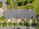 Aerial view of townhomes with well-maintained lawns and landscaping, plus individual driveways at 3245 Major Samuals Way, Charlotte, NC 28208