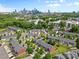 Aerial view of a community with green spaces and downtown skyline in the background at 3245 Major Samuals Way, Charlotte, NC 28208