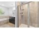 Inviting bathroom features a soaking tub, dark wood vanity, and glass-enclosed tile shower at 3245 Major Samuals Way, Charlotte, NC 28208
