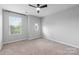 Bedroom with a ceiling fan, neutral carpet, and round window, creating a relaxing space at 3245 Major Samuals Way, Charlotte, NC 28208