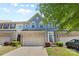 Charming townhome showcasing a blue facade, brick accents, and a well-maintained front yard at 3245 Major Samuals Way, Charlotte, NC 28208