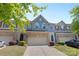 Charming townhome showcasing a blue facade, brick accents, and a well-maintained front yard at 3245 Major Samuals Way, Charlotte, NC 28208
