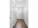 Bright and welcoming hallway featuring hardwood floors and a modern pendant light at 3245 Major Samuals Way, Charlotte, NC 28208