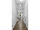 Inviting hallway with hardwood floors leading to a staircase and bright living space at 3245 Major Samuals Way, Charlotte, NC 28208
