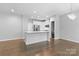 Open-concept kitchen featuring white cabinets, stainless steel appliances, and a breakfast bar at 3245 Major Samuals Way, Charlotte, NC 28208
