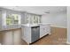 Spacious kitchen island with stainless steel dishwasher and sink; open concept with connecting rooms at 3245 Major Samuals Way, Charlotte, NC 28208