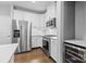 This kitchen features stainless steel appliances, white cabinets, and hardwood floors at 3245 Major Samuals Way, Charlotte, NC 28208