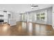 Open-concept living space showcasing hardwood floors, bright windows, and modern lighting fixtures at 3245 Major Samuals Way, Charlotte, NC 28208