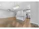 Modern living space featuring hardwood floors, a chandelier, and an open layout to the kitchen at 3245 Major Samuals Way, Charlotte, NC 28208