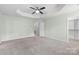 Large main bedroom features tray ceiling, plush carpeting, and leads into an organized walk-in closet at 3245 Major Samuals Way, Charlotte, NC 28208