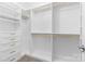 Organized walk-in closet with built-in shelving, drawers, gold hardware and ample storage space at 3245 Major Samuals Way, Charlotte, NC 28208