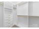 Well-organized walk-in closet includes shelving, drawers with gold hardware, and multiple clothing rods at 3245 Major Samuals Way, Charlotte, NC 28208