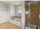 Well-lit bathroom featuring a soaking tub and a separate shower with glass doors at 3300 Paul Heavner Ln, Lincolnton, NC 28092