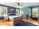 Comfortable bedroom with hardwood floors, ceiling fan, natural light, and ample closet space at 3300 Paul Heavner Ln, Lincolnton, NC 28092