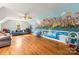 Spacious bonus room featuring custom mural, ceiling fan, hardwood floors, and plenty of natural light at 3300 Paul Heavner Ln, Lincolnton, NC 28092