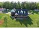Aerial view of a charming two-story home with a well-manicured front yard and inviting front porch at 3300 Paul Heavner Ln, Lincolnton, NC 28092