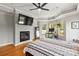 Spacious main bedroom featuring a fireplace, tray ceiling, and large windows at 3300 Paul Heavner Ln, Lincolnton, NC 28092