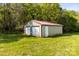 Backyard shed in the backyard with two garage doors and a side entry door on a grassy lot at 3300 Paul Heavner Ln, Lincolnton, NC 28092