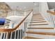 Elegant staircase showcasing wood treads, white risers, decorative railing, and natural light at 3300 Paul Heavner Ln, Lincolnton, NC 28092