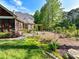 Lush backyard with well-maintained lawn and colorful garden beds, providing a vibrant outdoor living space at 3519 Weddington Oaks Dr, Matthews, NC 28104