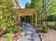 Charming backyard patio with a wooden pergola that provides an area to relax and enjoy the outdoors at 3519 Weddington Oaks Dr, Matthews, NC 28104