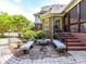 Brick patio with outdoor seating and lush landscaping that compliments the house's brick exterior at 3519 Weddington Oaks Dr, Matthews, NC 28104