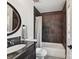 Well-appointed bathroom featuring a shower-tub combo with dark tile and granite vanity at 3519 Weddington Oaks Dr, Matthews, NC 28104