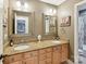 Bathroom featuring double vanity with granite countertop, framed mirrors, and stylish lighting fixtures at 3519 Weddington Oaks Dr, Matthews, NC 28104